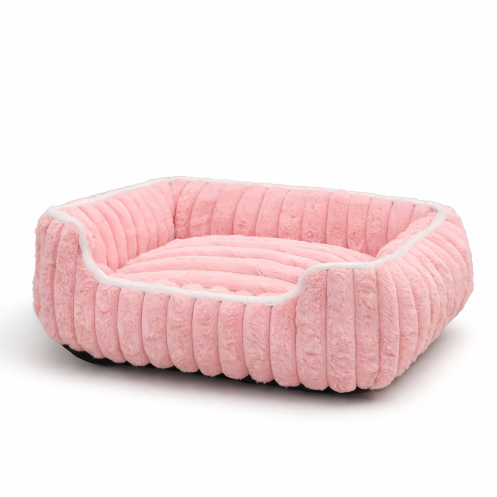 Pink pet bed with white trim on a white background