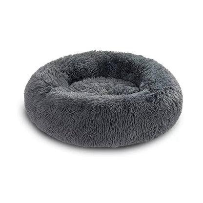 Round plush pet bed designed for small dogs, featuring a deep cushioned sleeping area with raised edges that provide comfort, support, and a secure resting space