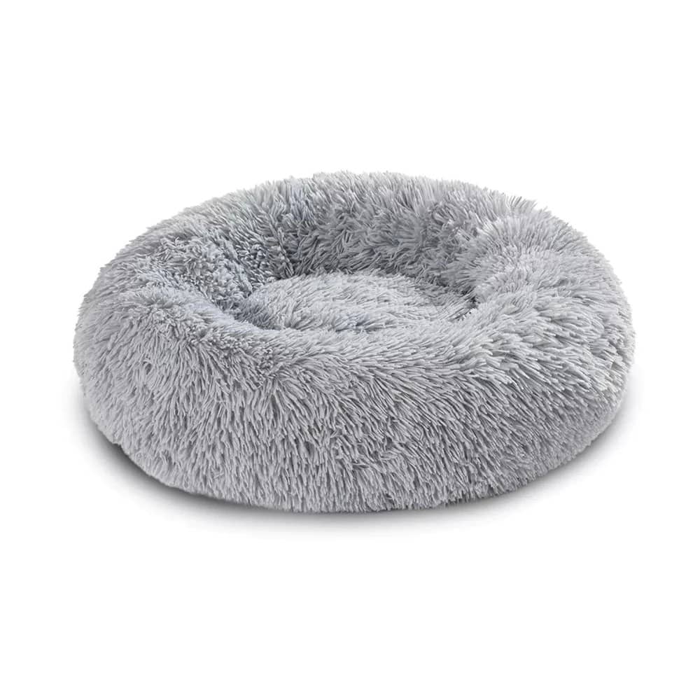 Round plush pet bed designed for small dogs, featuring a deep cushioned sleeping area with raised edges that provide comfort, support, and a secure resting space
