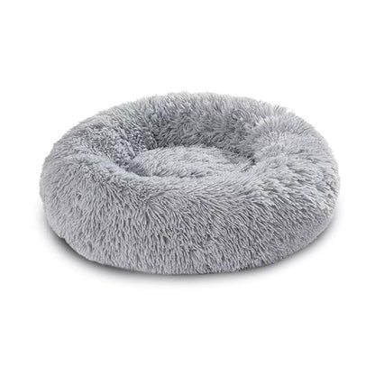 Round plush pet bed designed for small dogs, featuring a deep cushioned sleeping area with raised edges that provide comfort, support, and a secure resting space