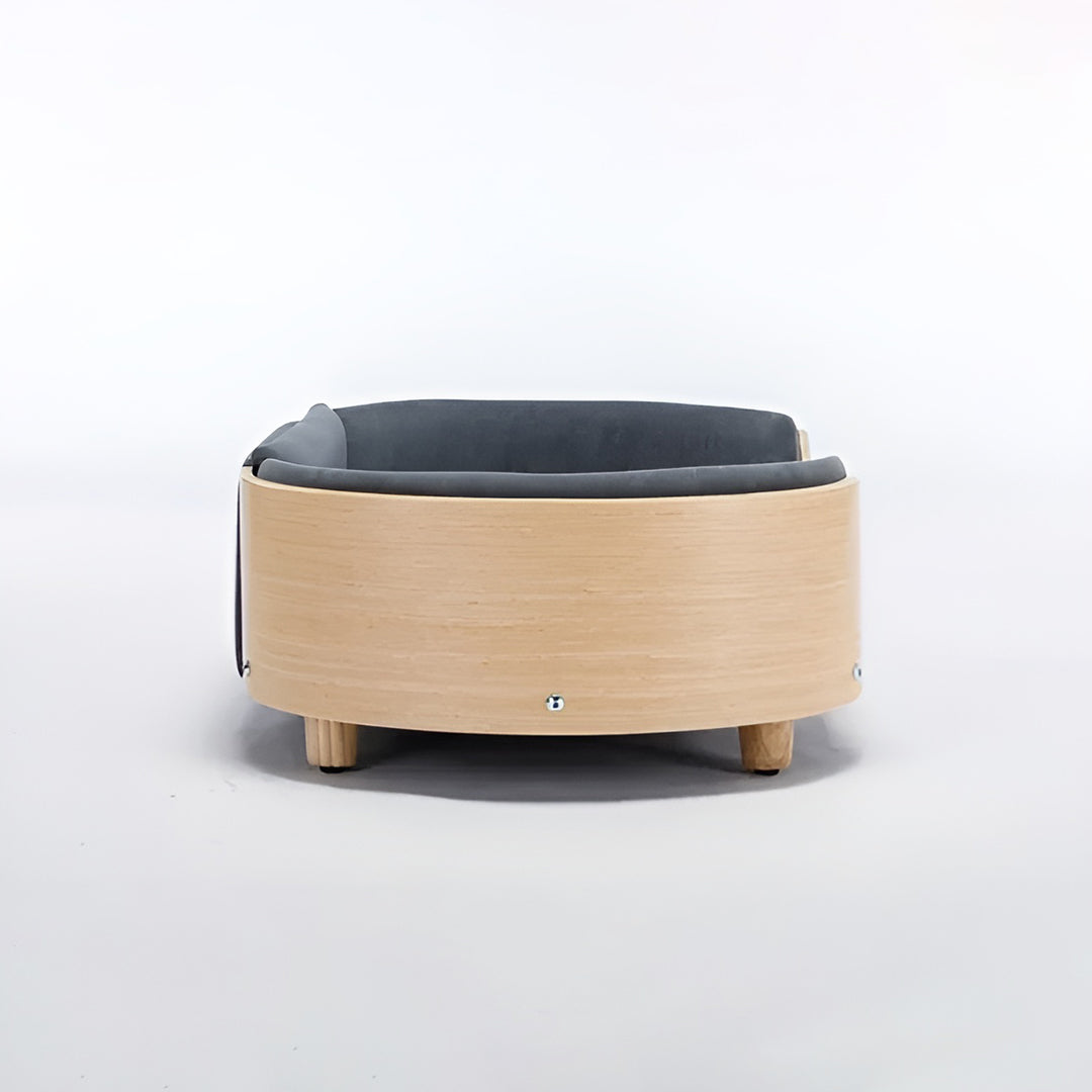 Scandinavian style elevated pet sofa bed designed for dogs, featuring a cushioned sleeping surface with curved supportive sides and raised legs for comfortable lounging and rest