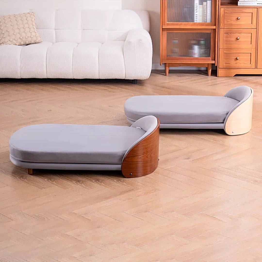 Scandinavian style elevated pet sofa bed designed for dogs, featuring a cushioned sleeping surface with a curved wooden side panel and raised base for supportive and comfortable resting